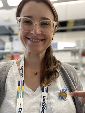 Andrea Pereyra wears a souvenir pin featuring empanadas, one of Argentina's staple foods, and a ribbon in the national colors, that she purchased from a market in Buenos Aires.