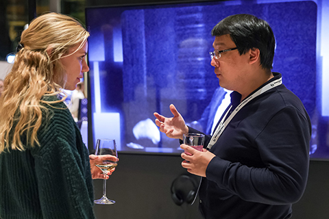 Katy Brewer talks to one of the presenters during a reception at the 2024 World Science Forum in Budapest.