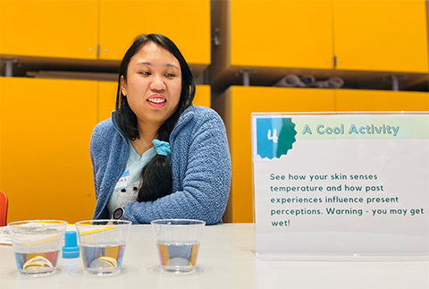 Jessica Desamero volunteers at the deceptively simple “A Cool Activity” during the Saturday Science BioBus event in March that focused on the senses of smell, sight and touch.