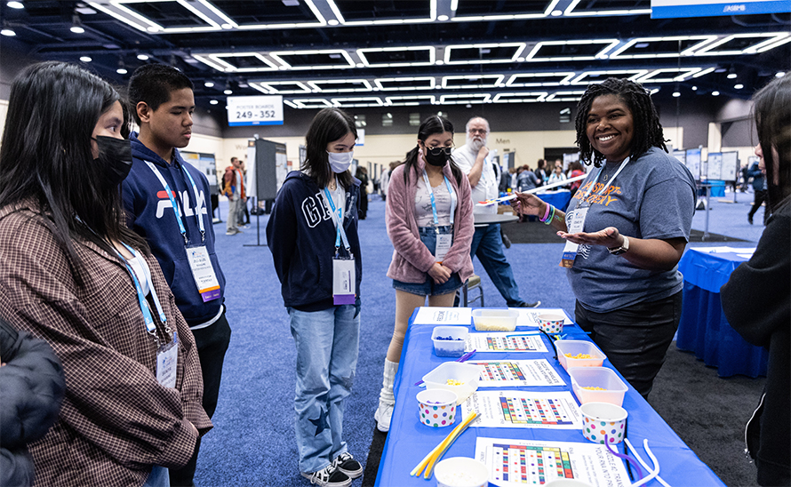 A member of the ASBMB Science Outreach and Communication Committee, Pollard leads Seattle-area high school students through the Escape the Cell activity during the 2023 ASBMB Annual Meeting.