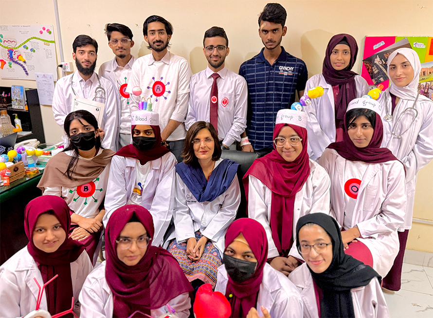 Fatahiya Kashif, center, surrounded by members of the Federal College ASBMB Student Chapter. Back: Sidique, Ali Hassan, Ahmed, Ali Ahmed, Muhammad Ali, Hafsah and Romayssa. Middle: Javeria, Hira, Aqsa and Afreen. Front: Mahpara, Momina, Adina and Minahil.