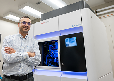 Researcher Ben Orlando stands alongside one of Michigan State's cryogenic electron microscopes. Orlando utilizes cryo-EM to study membrane protein complexes.