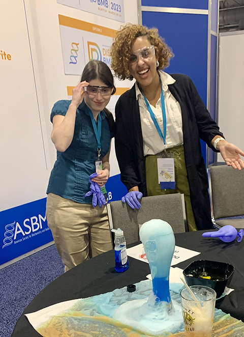 Adriana Norris and Christina Swords, both members of the Science Outreach and Communication Committee, demonstrate dry ice experiments at the 2022 ASBMB Annual Meeting in Philadelphia.