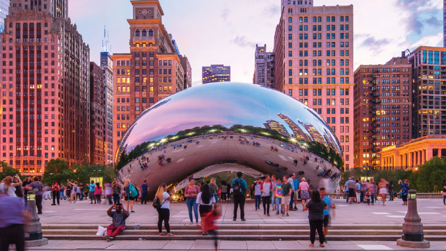 People gathered around the Cloud Gate sculpture in Chicago