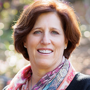 Headshot of Susan Marqusee wearing a scarf. 