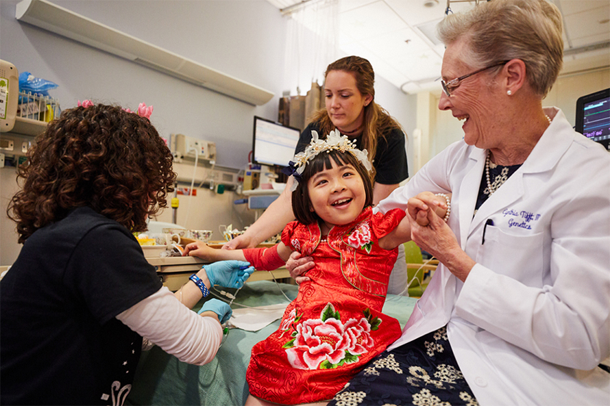 Jojo, the first recipient of a new GM1 gangliosidosis gene therapy treatment, and Cynthia Tifft, an author on the JLR study, celebrate with a tea party.