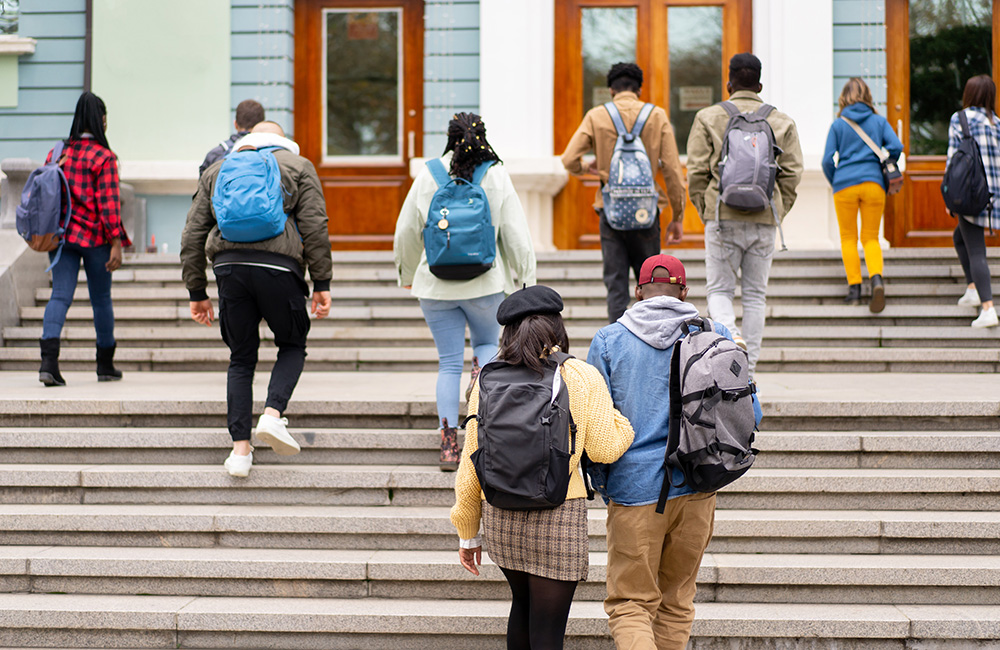 stock photo of students entering college building