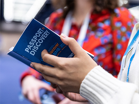 A Seattle-area high school student holds a “Passport to Discovery” booklet, provided as part of Community Day.